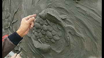 Create a relief of two carp chasing each other / with sand cement
