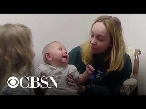 Baby girl gets first hearing aids, can't stop laughing at big sister's voice