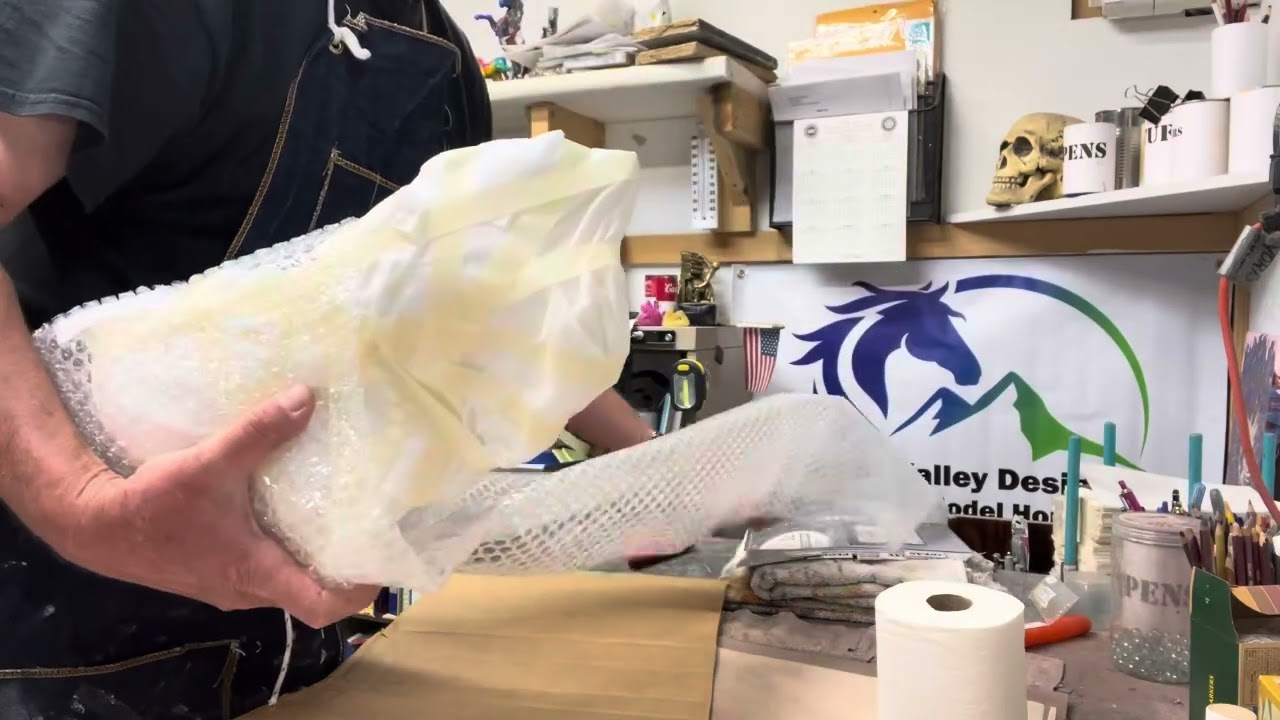 WRAPPING AND BOXING THREE  MODEL HORSES FOR SHIPPING.