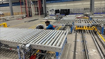 Refrigerator Assembly line conveyor with loading and retrieval system for performance testing.
