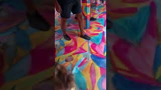 Little girl runs around colorful rainbow mirror maze then crashes into wall and bumps head