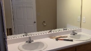 I show an easy & safe way to remove a glued mirror off a wall.