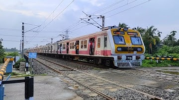 Modern High speed ICF MEDHA EMU local trains are passing busy railroad crossing : railgate Video