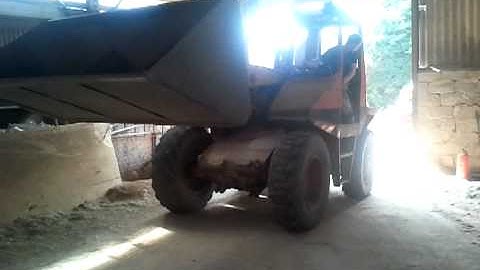 Muir Hill tractor loading sawdust for briquette production