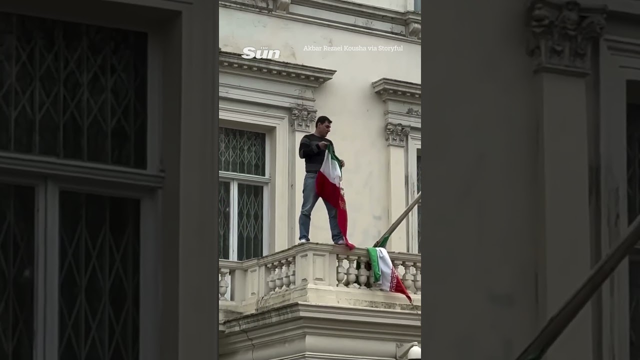 Protester tears down Iran flag from embassy in London as demos spread across world