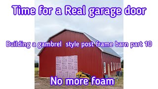 Building a gambrel  style post frame barn part 10 finally installing the garage door