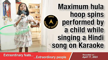Maximum hula hoop spins performed by a child while singing a Hindi song on Karaoke