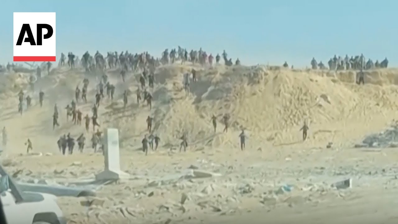 Video shows crowds of Palestinians running towards aid trucks in Gaza