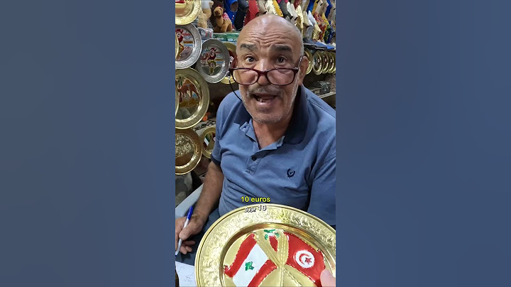Purchasing a craft from a souvenir shop in Tunis's old Medina while conversing in Arabic with locals