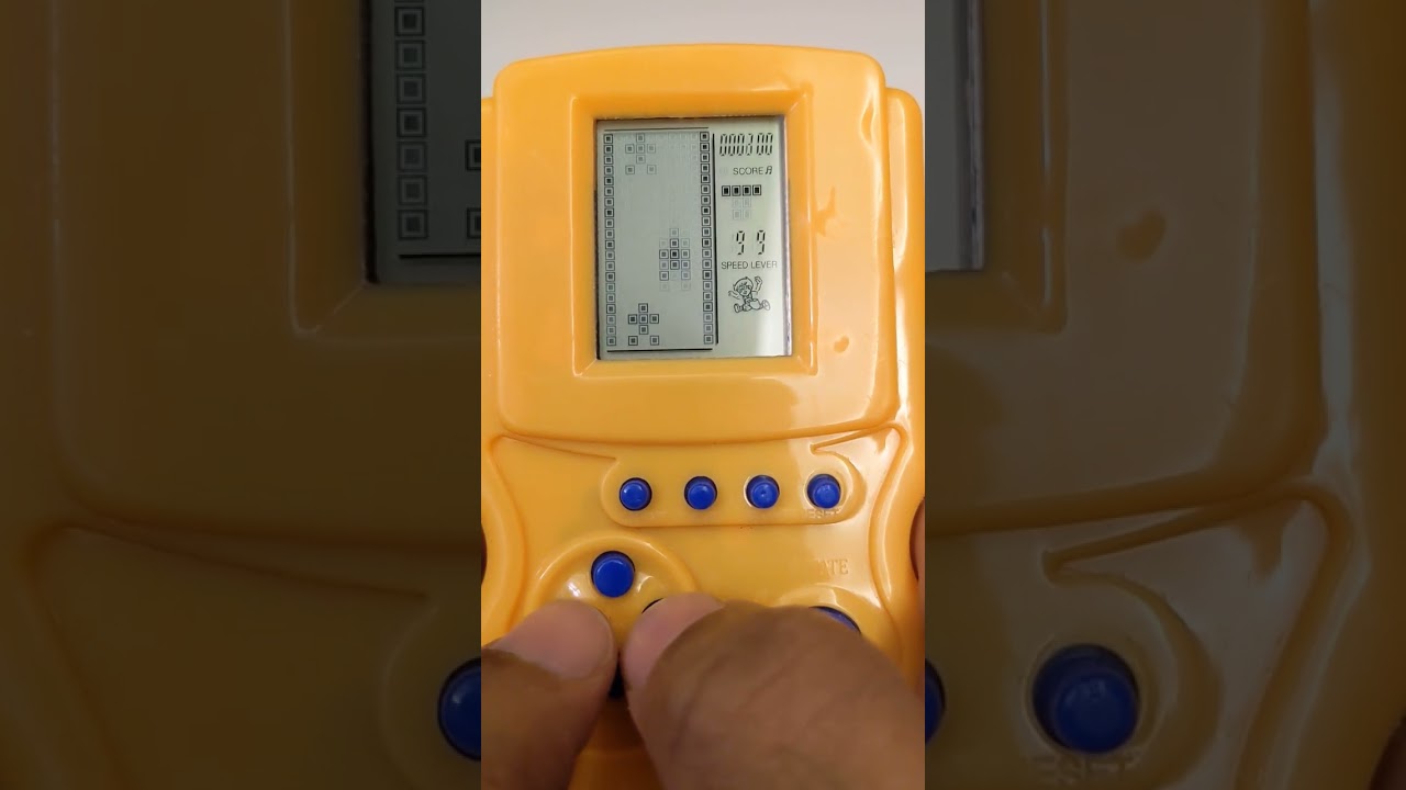 Retro hand held video game console - Playing car racing.                                       