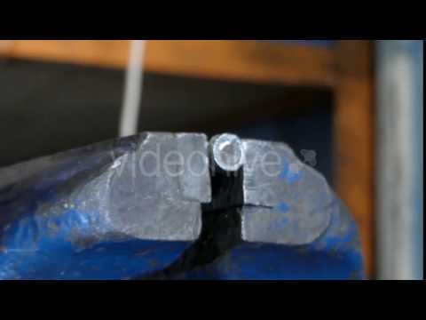 Hacksaw Cuts a Bolt.