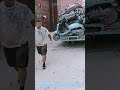 Scrap collector stacks old broken scooters onto his small tricycle