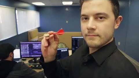 Guy Throws Dart Into Co-worker