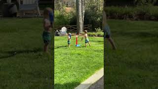 Boy hits baseball from batting tee and balls hits brother on his face