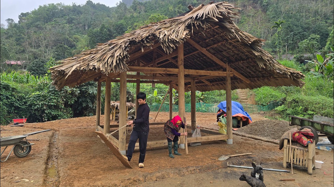 Thanh and the old woman were digging and leveling the ground in preparation for pouring concrete.