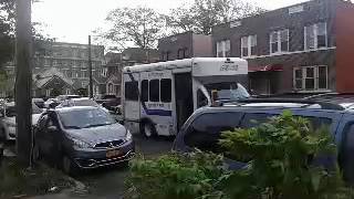 An Access-A-Ride Bus making a pass through for pick-up