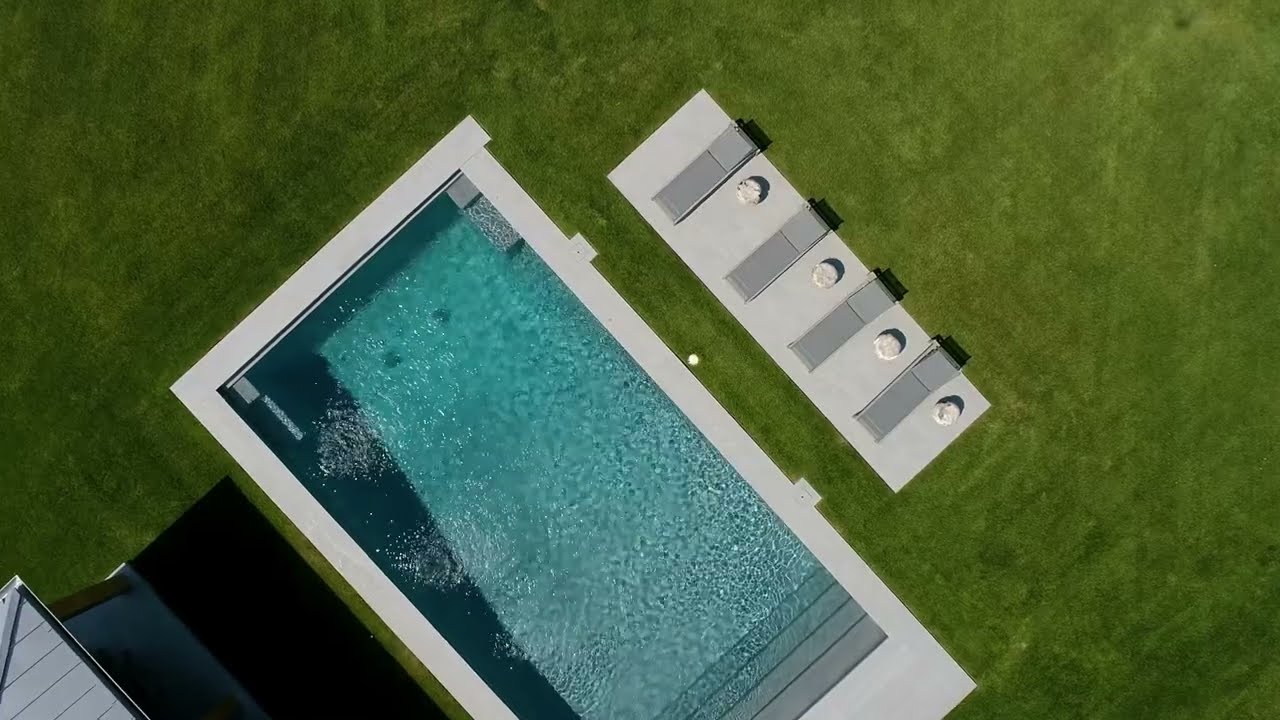 Modern Pool Area with Light Grey Porcelain Pavers, Steps, and Copings in Hamptons, NY