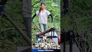 Woman Using A Automatic Log Splitter - The Workers Do Their Job Perfectly