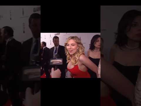 A woman completely disappears behind Scarlett Johansson on the red carpet