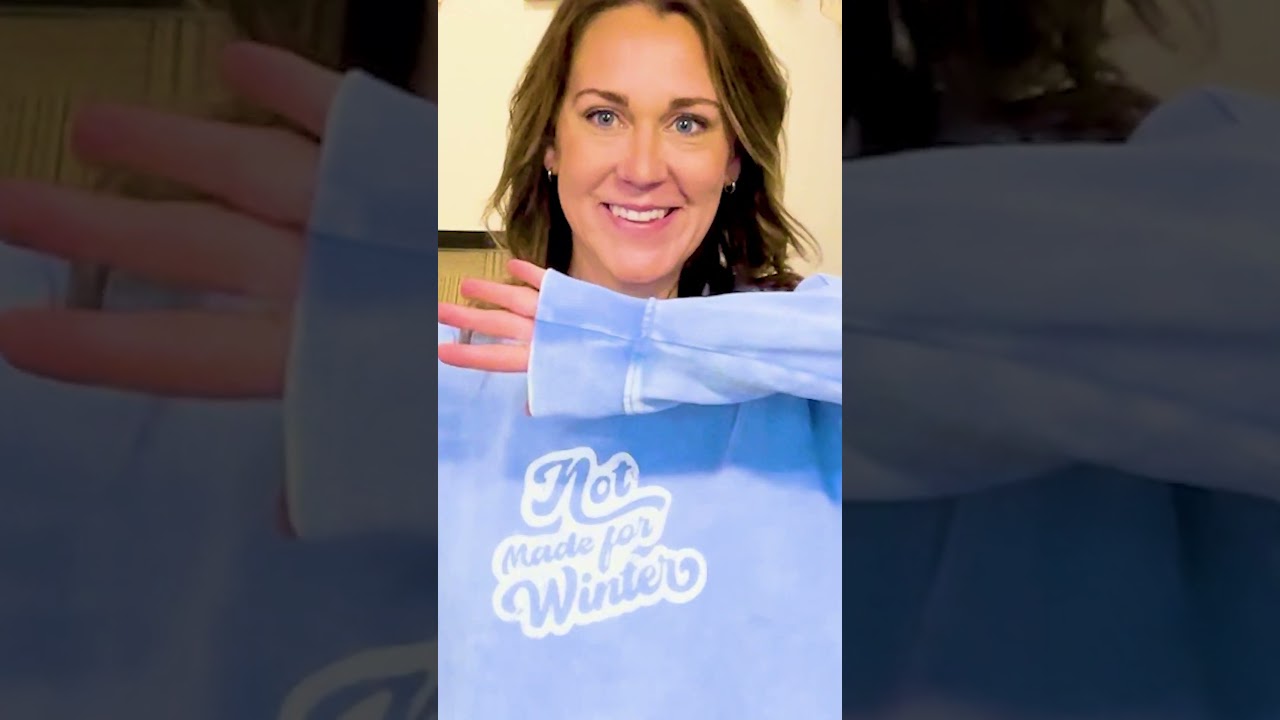 Jennifer stands out in a blue sweater with "Not Made For Winter", playful and bold.