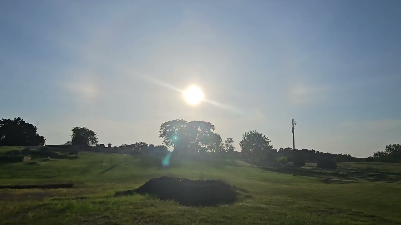 Some kind of rainbow around the sun walking around the graveyard.