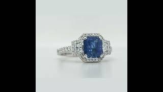 Three-stone radiant sapphire, trapezoid diamonds, halo and pavé diamonds ring
