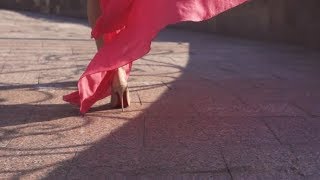 Girl In A Billowing Dress In The Wind Goes In The Rays Of The Setting Sun Against The Background Of