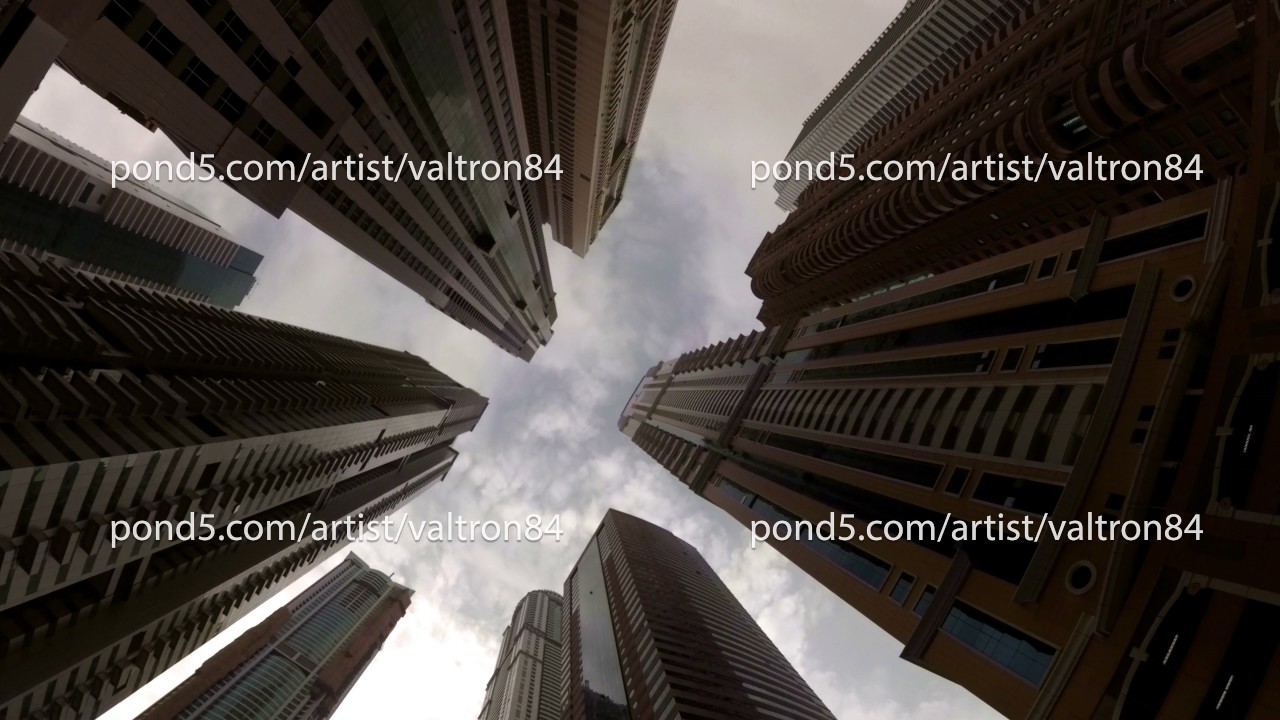 clouds float between the high-rise buildings in Dubai, UAE