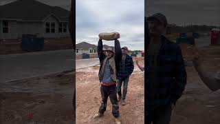 Guy Cut a Cement Bag Open While Another Was Holding It Up