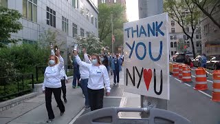Frontline workers hold vigil to honor victims of COVID-19