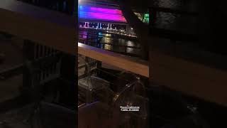 Guy lifts friend over shoulder and tosses him over a bar into the water and goes along for the ride