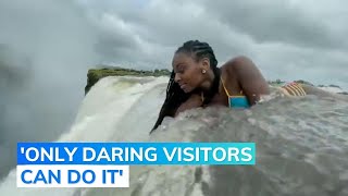 ‘Daring’ Woman Leans over Edge of Victoria Falls