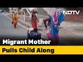 Boy sleeps on suitcase wheeled by mother: video tells migrants' plight