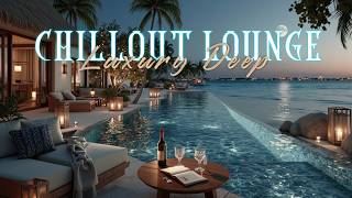 Luxurious beachfront house with pool, sofas, glasses, bottle and candles