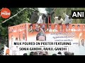 Congress workers pour milk on poster featuring sonia gandhi rahul gandhi and revanth reddy