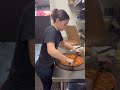Pizza girl with a mega meat one of out specialty pizzas. ripping and flipping-turning and earning.