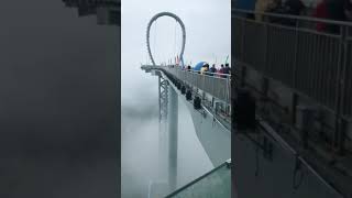 Glass corridor in the cloud,Beautiful suspended platform and waterfall