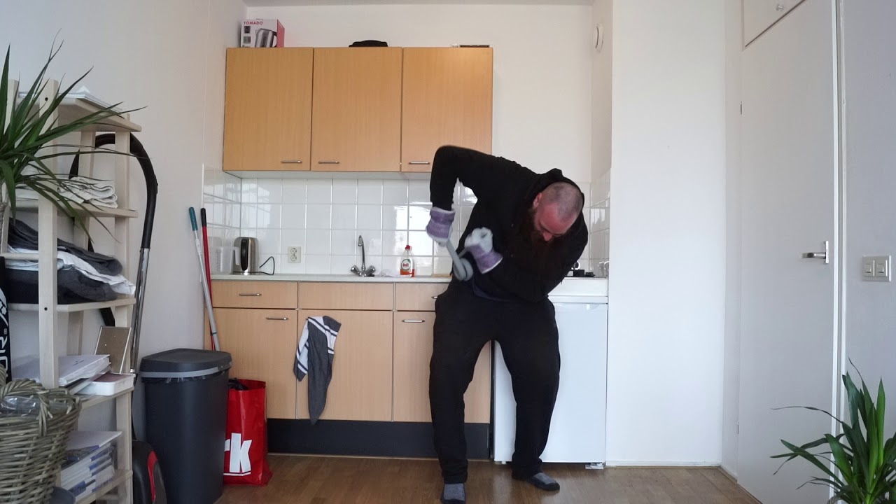 Strongman bending two 25x5 mm steel bars at the same time into two