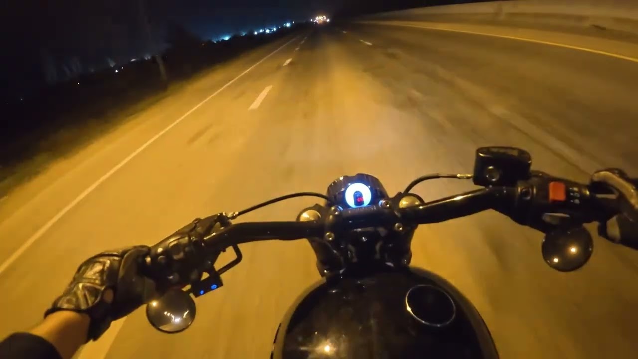 Triumph Bonneville T120 Tracker On the road at night during the sugarcane harvest