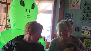 Inflatable costume alien are chasing a tiny kitten 