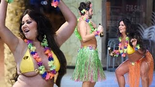 Busty Big Brother star Lisa Appleton does her best Hawaiian dance routine as she drinks beer in biki