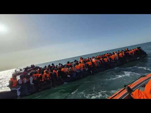 Outraged protesters clash with police after mega-dinghy carrying 140 migrants arrives in UK