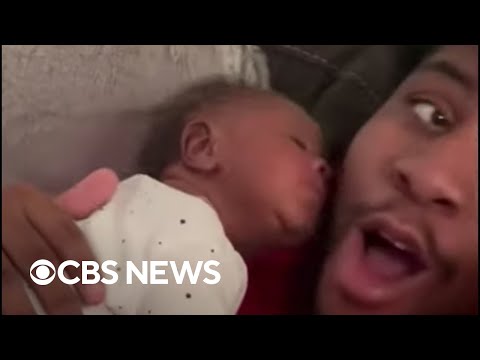 Newborn surprises dad with kiss