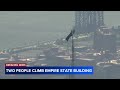 Two people climb to the top of the Empire State Building