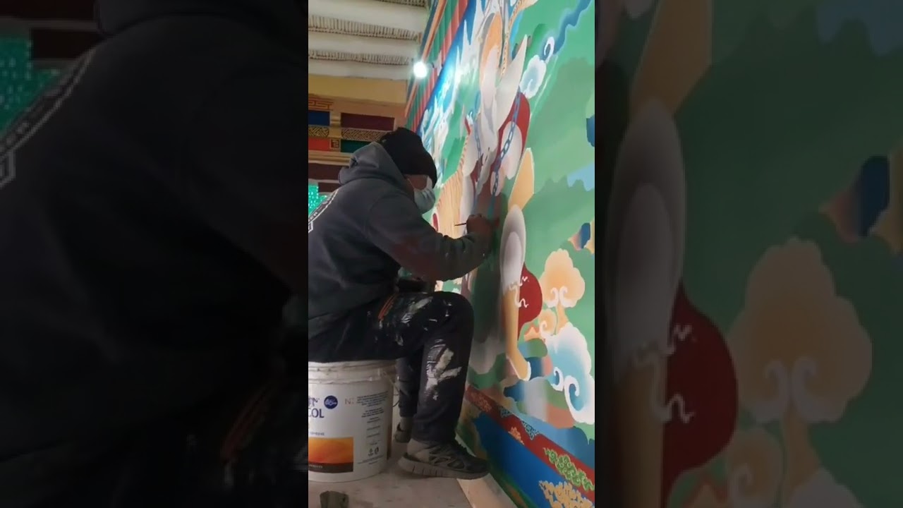 Artists painting the walls of Thiksey Monastery. 