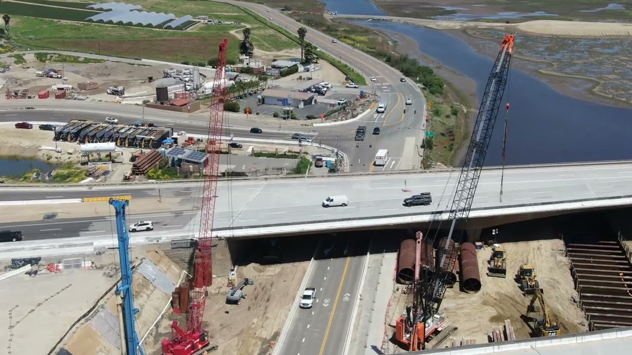 Aerial view of bridge construction crossing the highway in California | Free Stock Video