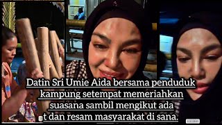 Datin Sri Umie Aida bersama penduduk kampung setempat memeriahkan suasana sambil mengikut adat 