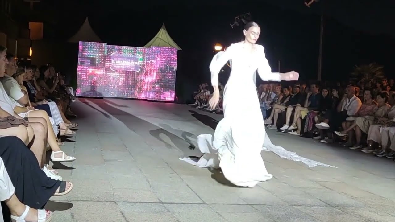 Model Natalia Garaiko TRIPS on her long dress during Zarautz Modan 2022 Fashion Show