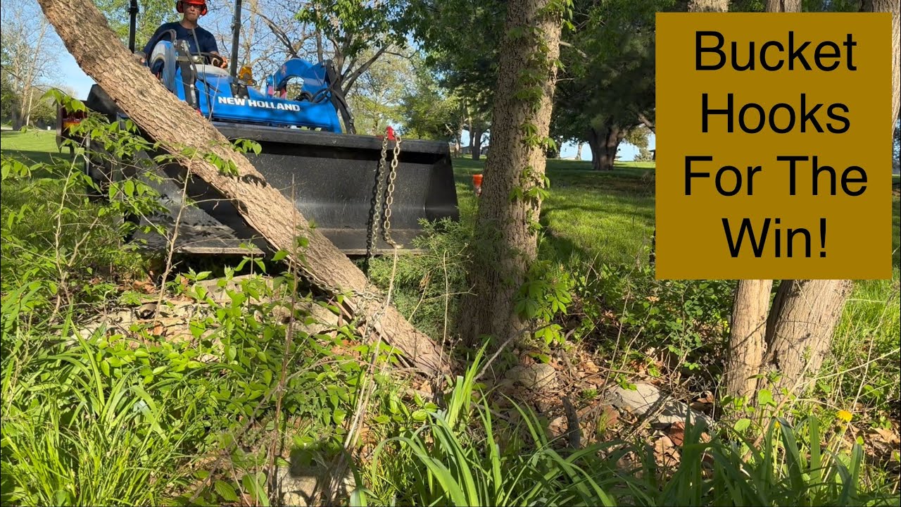 Cleaning up a dangerous fallen tree with the bucket hooks and chain ...
