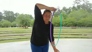 Beginner Hula hoop trick: Palm Spin BTB arm flip.